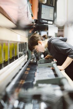 a woman working on an assembly line in a factory