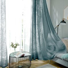 a living room with a couch, coffee table and curtains