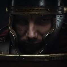 a close up of a man wearing a helmet and looking at something in the distance