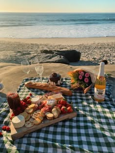 a picnic on the beach with wine and snacks