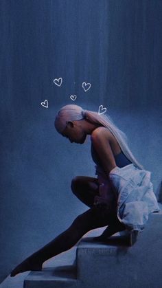 a woman sitting on top of a set of stairs with hearts drawn above her head