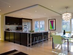 a blurry image of a kitchen and living room in a house with lots of windows