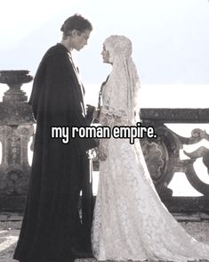 a man and woman standing next to each other in front of a fence with the words, my roman empire