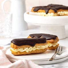 two pastries sitting on top of a white plate