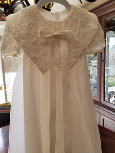 "FREE SHIPPING IN THE U.S. and reduced shipping rates for International orders. This beautiful gown is grandmother's wedding dress conversion, but it can be made new from similar fabric from my shop. Satin bodice with puffed sleeves and a scalloped lace edge. Organza skirt also has the scalloped lace edge. Beautiful large collar in the front with a bow (optional) Satin ribbon ties in the back of the waist. Bridal looping and satin buttons close the back. Matching bonnet included. Gown is made he Cream Baptism Gown With Fitted Bodice, Cream Organza Dress For Ceremony, Cream Organza Dress For Baptism, Organza Baptism Dress With Lace Bodice For Wedding, Fitted Cream Organza Baptism Dress, Cream Fitted Organza Baptism Dress, Lace Ball Gown For First Communion At Wedding, Cream Baptism Dress With Fitted Bodice, Fitted Organza First Communion Dress For Wedding