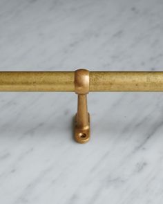 a close up of a brass handle on a marble surface