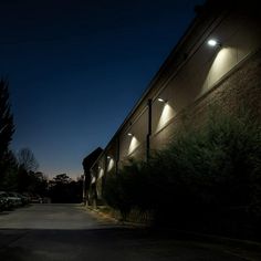 an empty parking lot at night with lights on