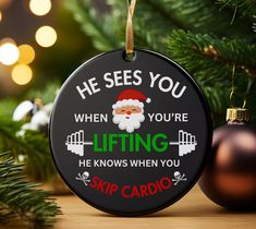 a christmas ornament that says he sees you when you're lifting he knows when you skip cardio