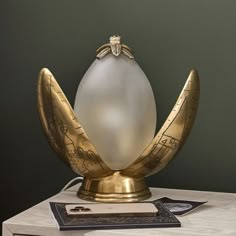 an egg shaped lamp sitting on top of a table