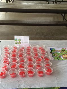 plastic cups are lined up on a table