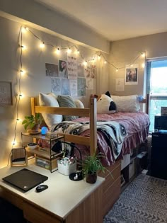 a bed room with a neatly made bed and lots of lights on the wall above it