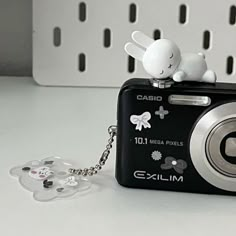 a camera key chain with an animal on it