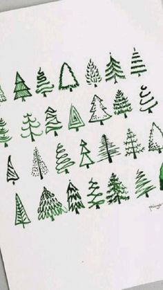 a piece of paper that has trees drawn on it with green marker pens and ink