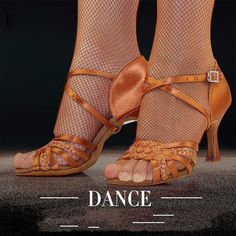 the legs and ankles of a woman wearing orange shoes with fishnet stockings on them