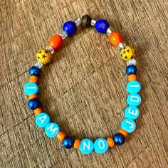 a beaded bracelet with the words i am not spelled in blue, orange and yellow beads