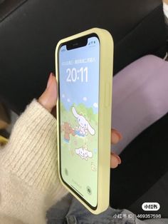 a person holding up an iphone case with cartoon images on it's back cover