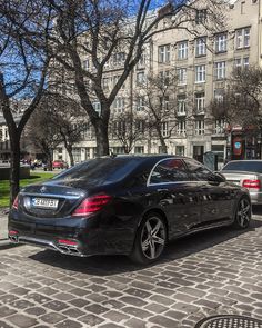 a black car parked on the side of a street