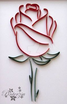 a paper cut out of a rose on a white surface