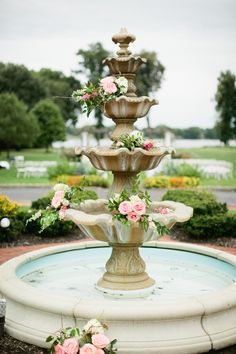 a water fountain with flowers on it