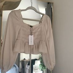 Cream Colored Top. Long Sleeve, Light, Airy Worth Ruched Front With A Tie. Size Medium. Material Is 100% Rayon. Spring Beige Ruched Top, Casual Neutral Blouse For Brunch, Beige Ruched Blouse For Spring, Spring Beige Ruched Blouse, Summer Beige Ruched Blouse, Summer Ruched Beige Blouse, Trendy Neutral Blouse For Spring, Feminine Neutral Blouse For Day Out, White Puffy Sleeve Top