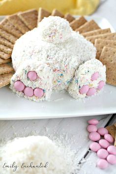 a white plate topped with marshmallows next to crackers