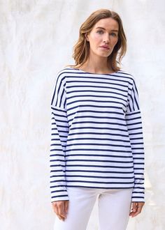 Elevate your French-girl game with this latest addition to our authentic Breton shirt collection! Tailored from our all-time best-seller shirt, MINQUIERS MODERNE, the MINQUIERS DROP features a more relaxed silouhette with dropped shoulders while maintaining the boyfriend fit and comfortable cotton we love. Made in Saint-James, Normandy, France. 100% lightweight cotton jersey. White Marine Style Long Sleeve Top, Navy Long Sleeve Marine Top, Marine Style Long Sleeve Cotton Tops, Navy Cotton Marine Style Tops, Navy Marine Style Cotton Top, White Sailor Style Long Sleeve Tops, White Marine Style Cotton Tops, Navy Cotton Nautical Tops, Cotton Sailor Style Top