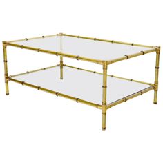 a gold bamboo coffee table with glass top