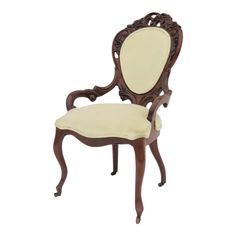 an antique style chair with white upholstered fabric on the back and armrests