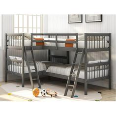 bunk beds with ladders are in the corner of a room that has white walls and wooden floors