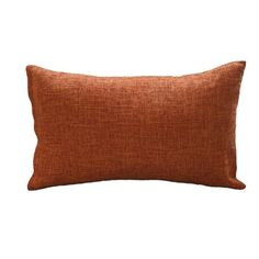 an orange pillow on a white background