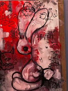 a painting with black and red paint on it's sides, depicting a rabbit