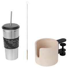 a coffee cup with a straw in it next to a mug holder