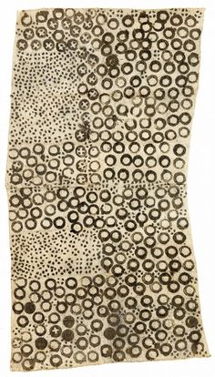 an old piece of cloth with circles and dots on the fabric, in black and white