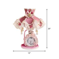 a pink and white clock sitting on top of a table