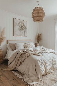 a large bed sitting in a bedroom on top of a wooden floor next to a window