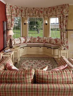 a living room filled with furniture and lots of windows