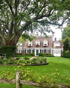 a large house surrounded by lush green grass