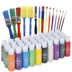 many different colors of paint and brushes are arranged in rows on a white background,