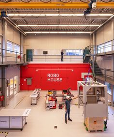 a man is standing in the middle of a large warehouse