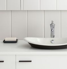 a bathroom sink sitting on top of a white counter