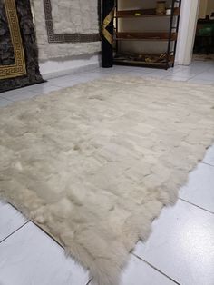 a white area rug in the middle of a room