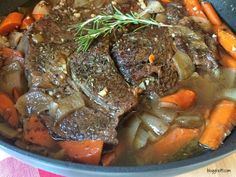 a pot filled with meat and vegetables on top of a table