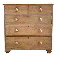 a wooden dresser with four drawers and knobs