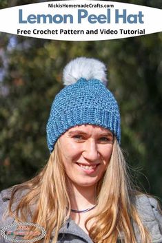 a woman wearing a blue knitted hat with a white pom - pom