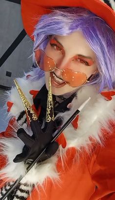 a woman with purple hair wearing an orange and white outfit