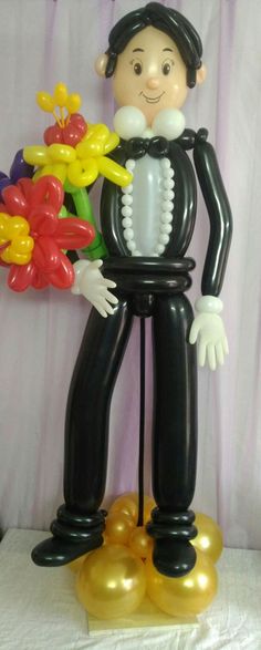 an inflatable balloon man with flowers and balloons