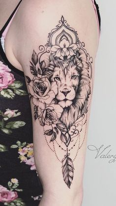 a woman's arm with a tattoo on it that has a lion and flowers