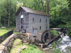 an old water mill in the woods near a stream