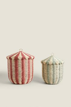 two woven baskets with lids on each side, one is red and the other is white