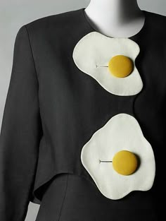 two fried eggs on top of each other in the shape of a woman's torso